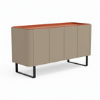 Coralie Sideboard left side view showing the curved cabinet, saddle leather top, dark handles, and stainless steel legs on a white background.