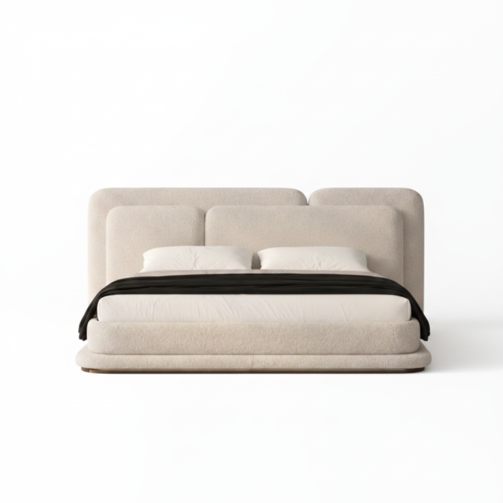 Kendric Bed straight-on front view with cream fabric frame, white bedding, and black throw