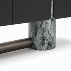 Wrenford Sideboard Close-up of the Wrenford Sideboard cylindrical stone leg, metal crossbar, and lower cabinet connection.