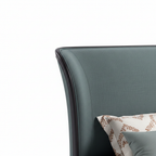 Avenoire Bed close-up of curved upholstered headboard edge detail on a white background
