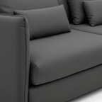 Caelis Sectional dark gray upholstery, seat seam, lumbar cushion, and fabric texture detail