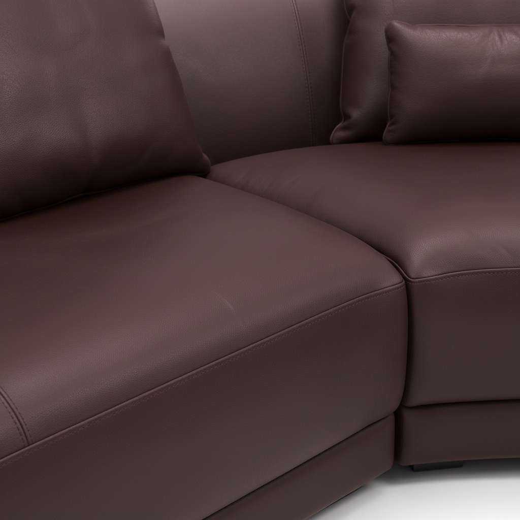 Elmont Sectional dark brown upholstery, curved seat seam, and leather texture detail