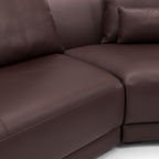 Elmont Sectional dark brown upholstery, curved seat seam, and leather texture detail