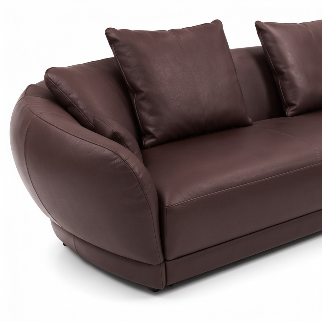 Elmont Sectional rounded arm, curved upholstery seam, and pillow detail