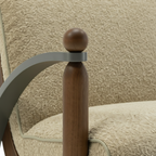 Foscano Accent Chair close-up showing the wooden support post and metal armrest detail