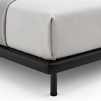 Haverique Bed close-up of black leather side frame detail on a white background