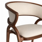 Amarante Dining Chair curved wood frame and cream upholstered backrest detail on white background