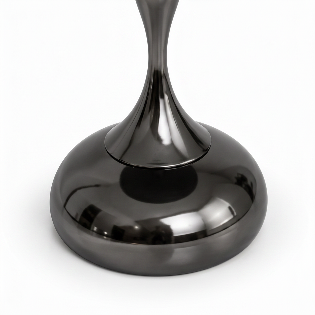 Angled close-up of the matte gunmetal stainless-steel pedestal and base on the Jervain End Table