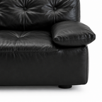 Liorenzo Sofa black leather arm cushion, seat stitching and foot close-up
