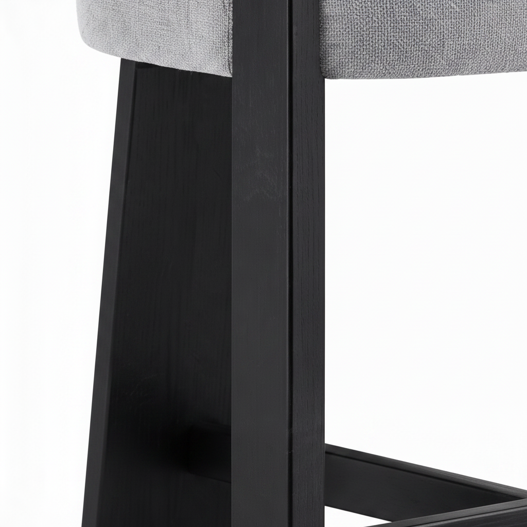 Westmere Noir Bar Stool solid ash wood grain, seat edge, leg joinery, and footrest detail on a white background