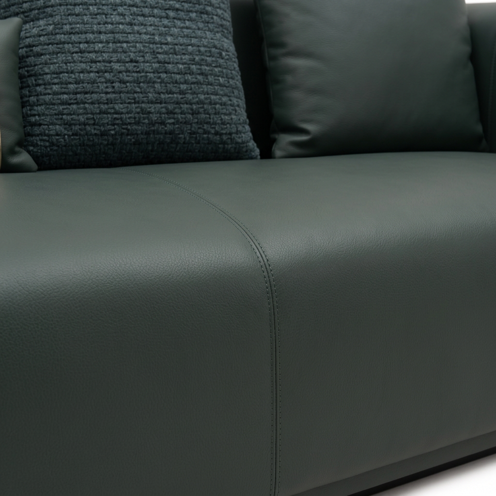 Rovessa Sofa dark green leather seat seam and textured back cushion close-up