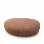 Close-up of the brown fabric texture and rounded upholstered edge on the Lacour Corsa ottoman.