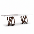 Marcelline Dining Table 45-degree right-facing view with white natural marble top and intertwined dark wood bases on a white background