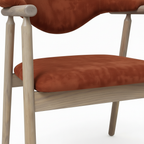 Thalia Dining Chair rust orange seat cushion and light wood leg detail on white background