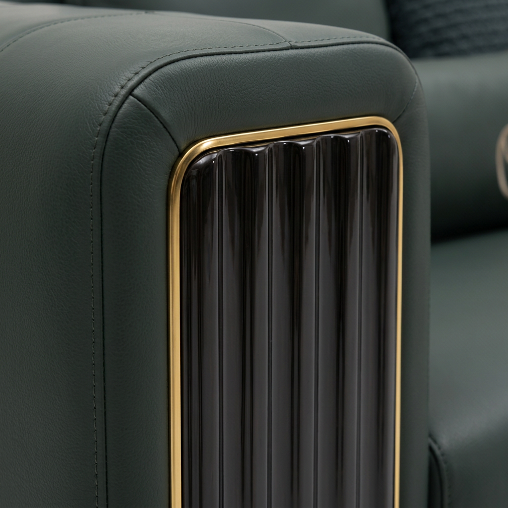 Rovessa Sofa armrest detail showing dark green leather stitching, black fluted panel and gold trim