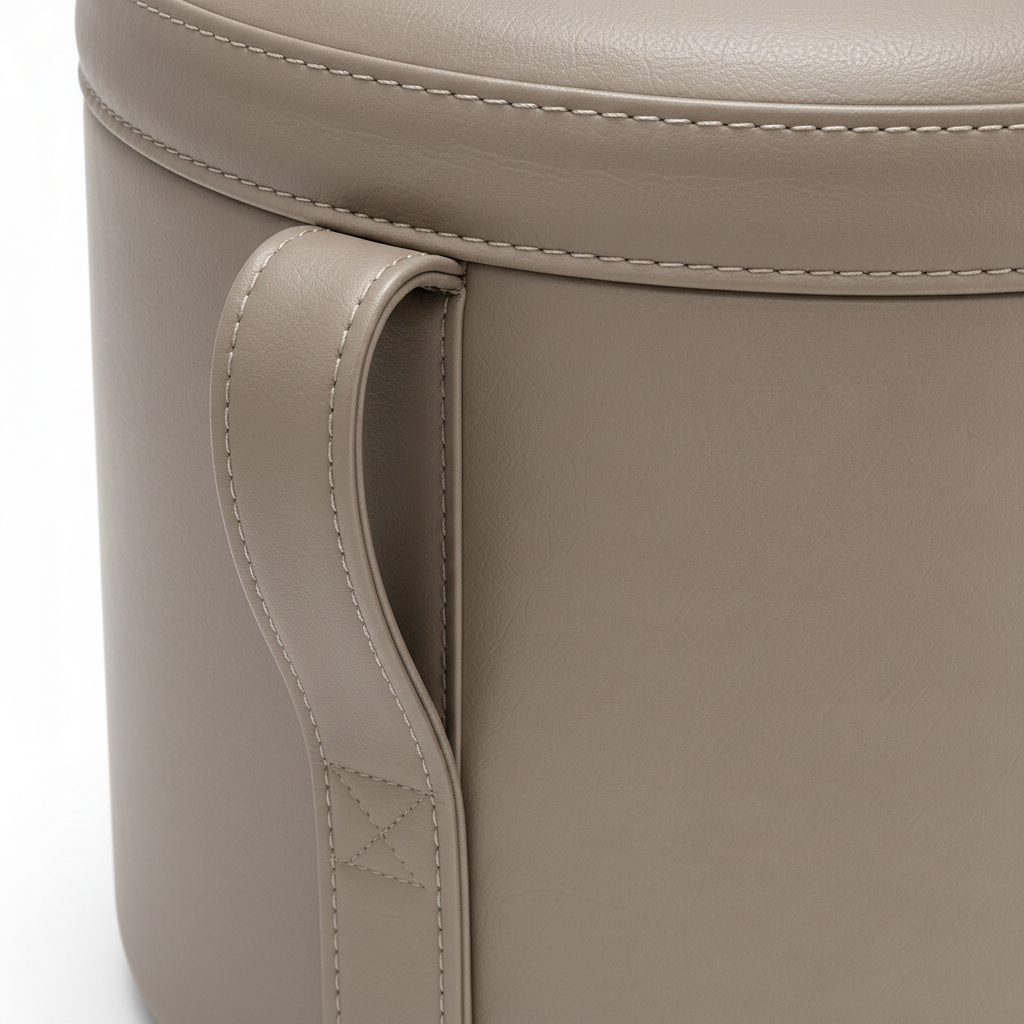 Close-up of the single faux-leather side handle and stitching on the Norevia End Table
