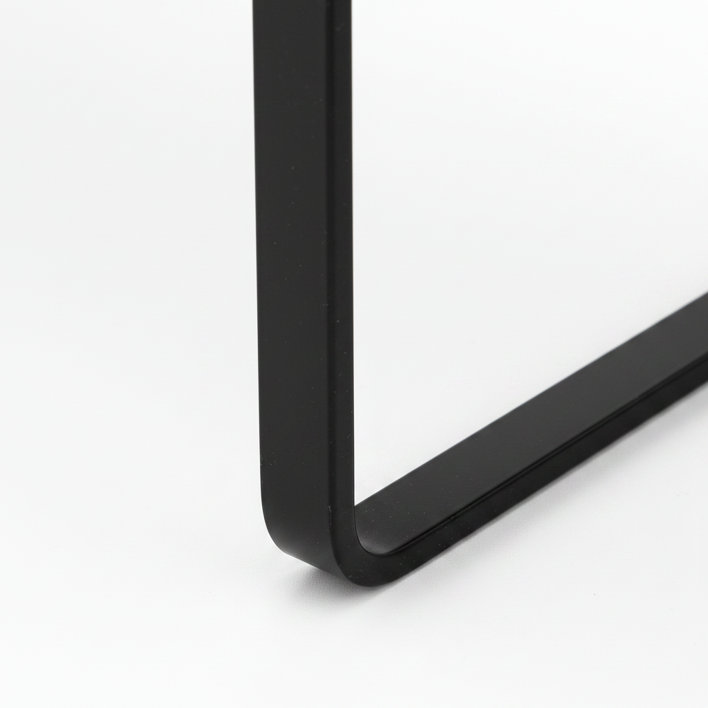 Close-up of the black U-shaped metal support on the Larsen Noir End Table