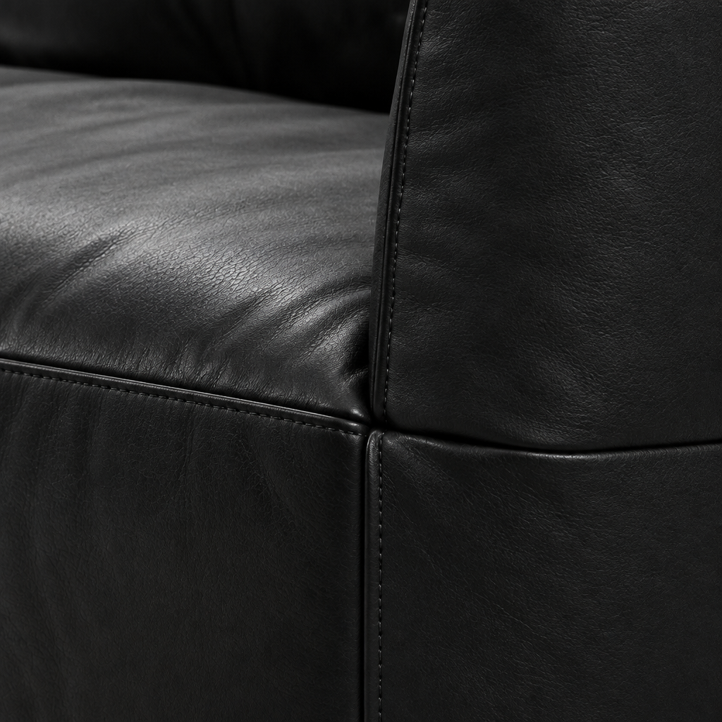 Selvano Sofa black leather upholstery texture and stitched seam detail on a white background