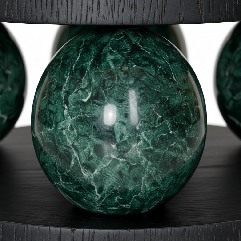Close-up of the polished green marble sphere and mineral veining on the Illyra End Table