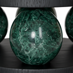 Close-up of the polished green marble sphere and mineral veining on the Illyra End Table
