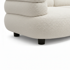 Close-up of the Wynmere sectional sofa leg and corner frame joinery with soft upholstery on a clean white background.