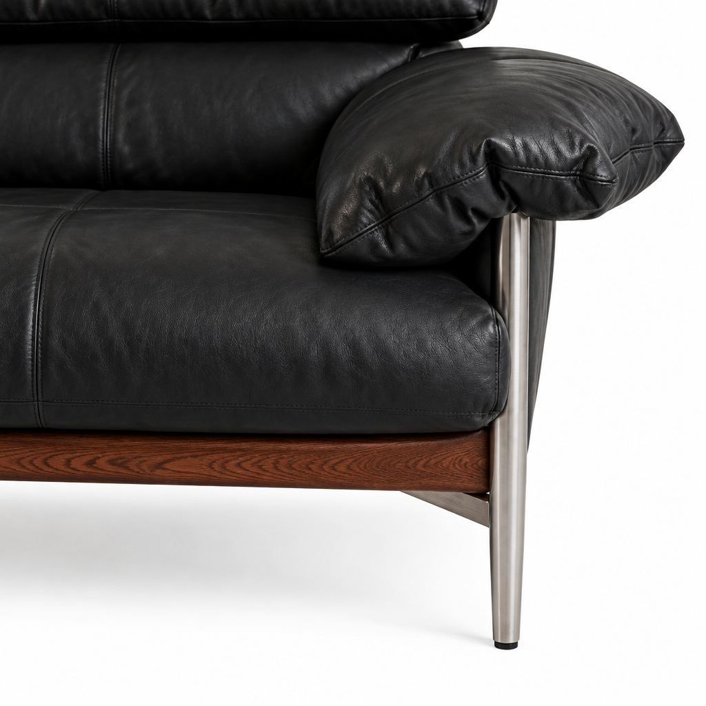 Marqueza Sofa black leather arm cushion, metal support and wood base close-up