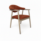 Thalia Dining Chair with rust orange upholstery and light wood, right-facing 45-degree view on white background