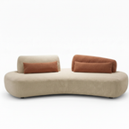 Lacour sectional in light neutral fabric with brown accent cushions, rounded front sofa view on a white background.