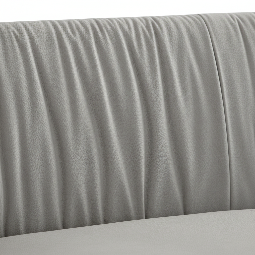 Close-up of the light gray fabric and pleated backrest channels on the Cordovan Sofa