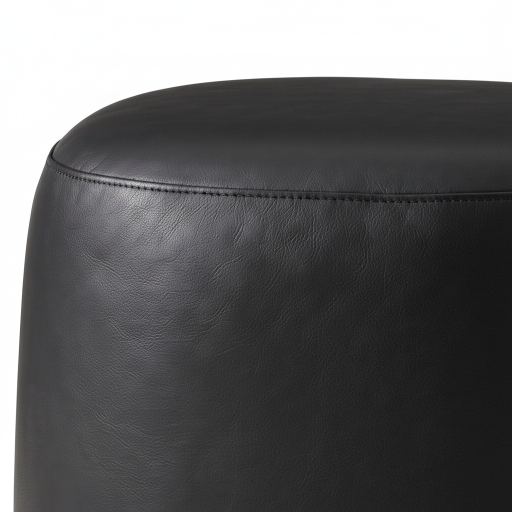 Gavelle stool black leather grain, padded top and stitched seam close-up