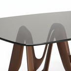 Close-up of Sorrento Dining Table translucent dark gray glass edge and ash wood support on white background