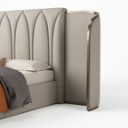 Iveronne Bed close-up of wingback side panel and metal trim detail on a white background