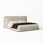 Kendric Bed left-side view with cream fabric headboard, white bedding, and black throw