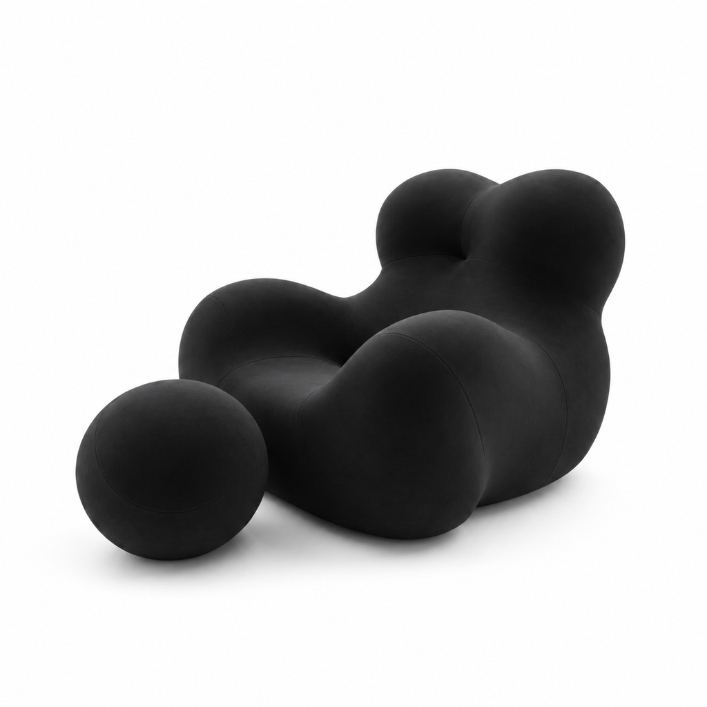 Mamma's Embrace Accent Chair — black upholstery and spherical footstool, three-quarter view facing left