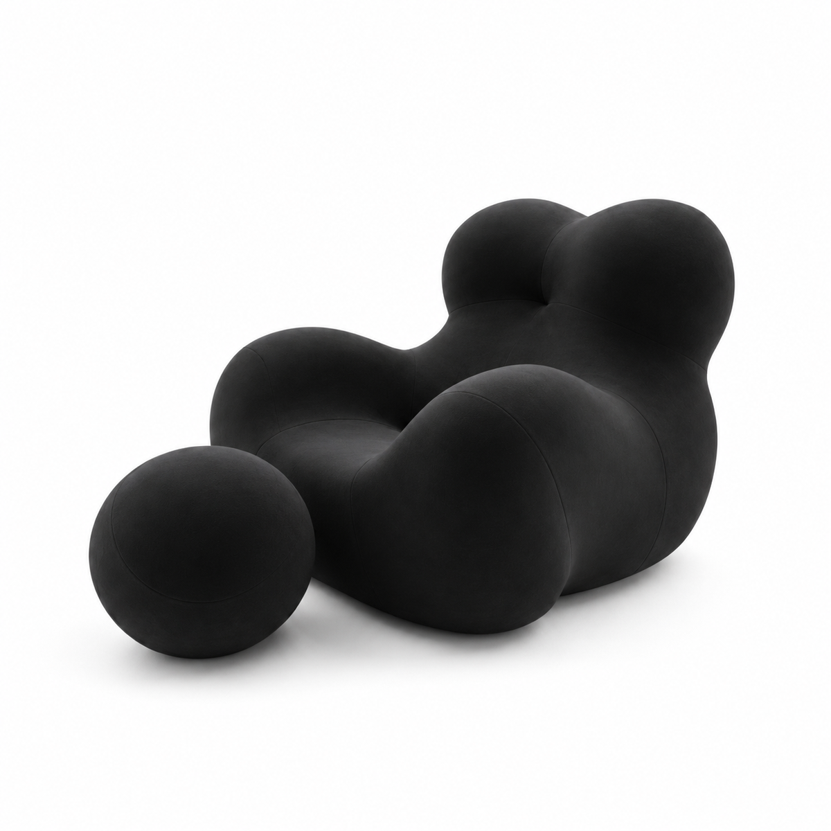 Mamma's Embrace Accent Chair — black upholstery and spherical footstool, three-quarter view facing left