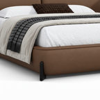 Mavero Leather Bed close-up of leather footboard and support foot detail on a white background