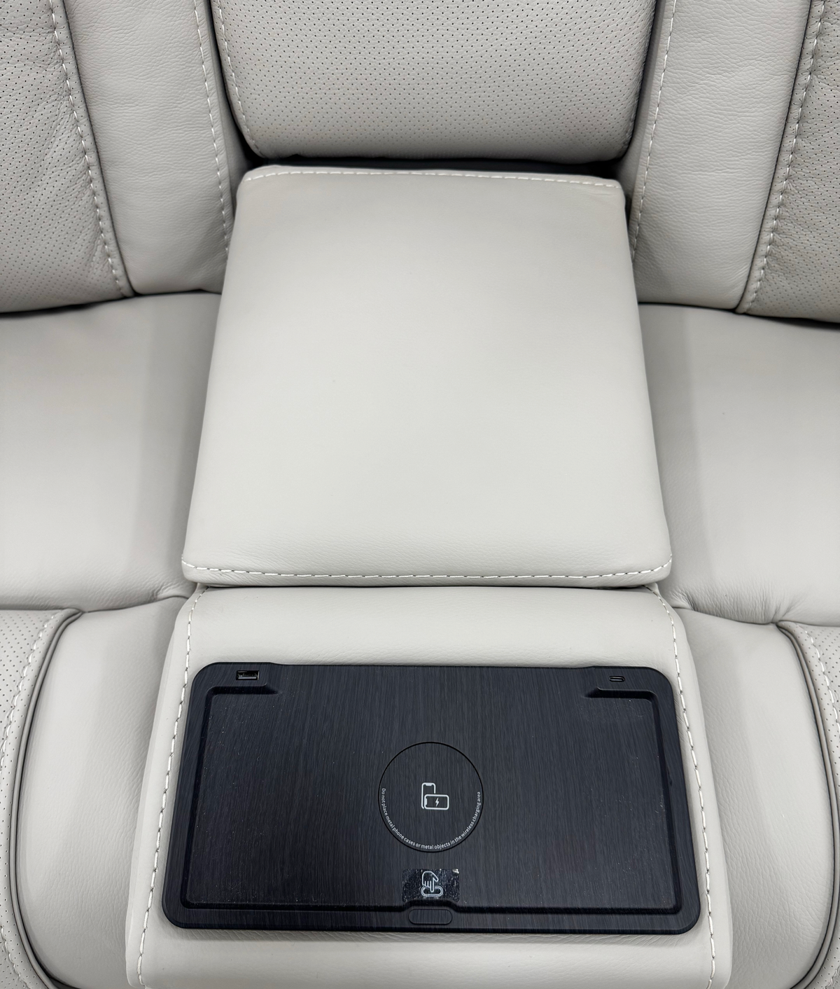 Montreval Console Loveseat in grey upholstery, center console panel and stitching detail, white background