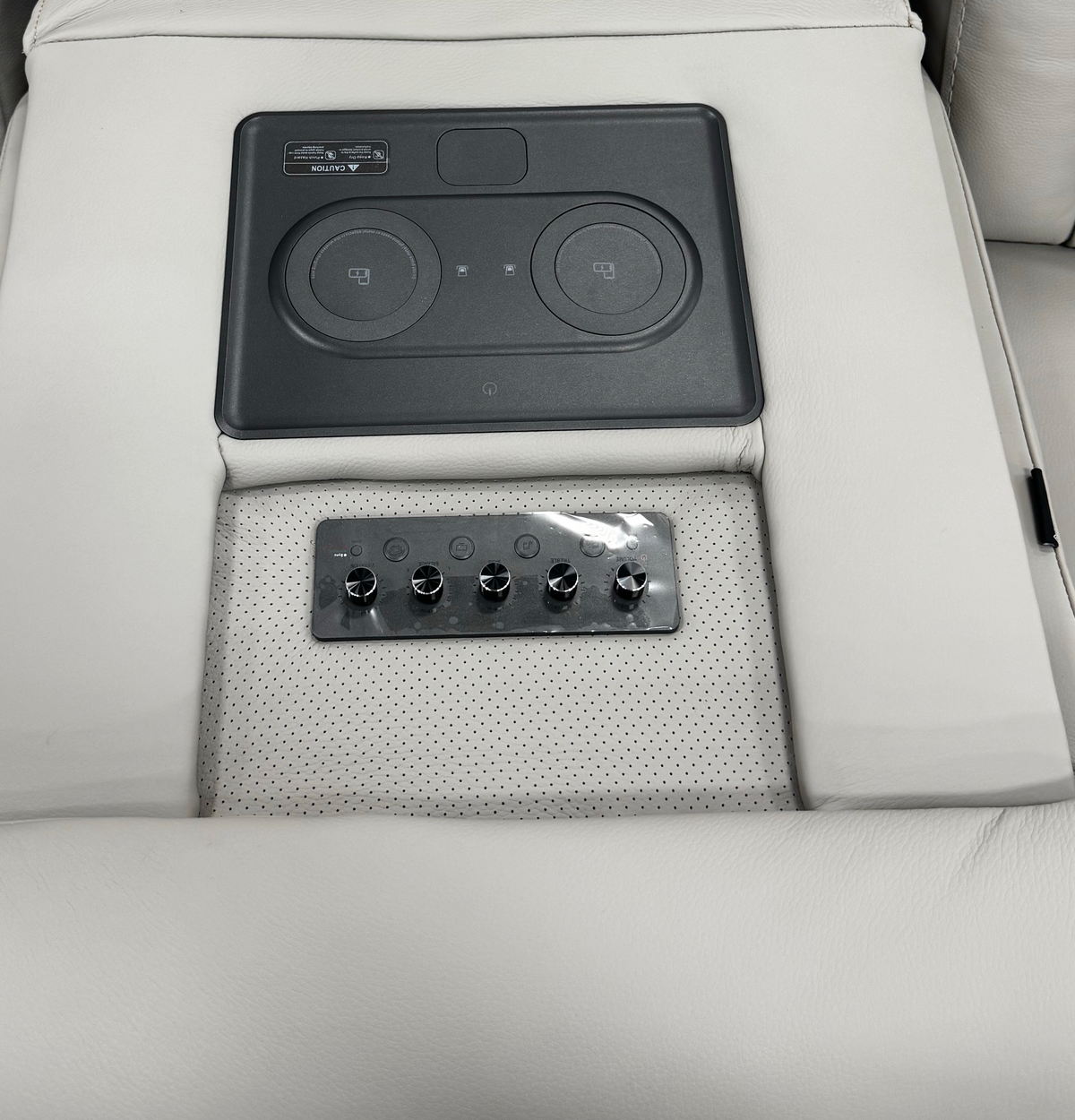 Montreval Sofa in grey upholstery, folded center-table control panel detail, white background