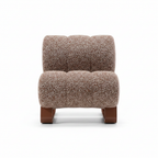 Savero Accent Chair front view in textured fabric with curved cushions and brown metal base on a white background.