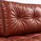 Wistere Sofa — Oxblood button tufting and waxed surface detail