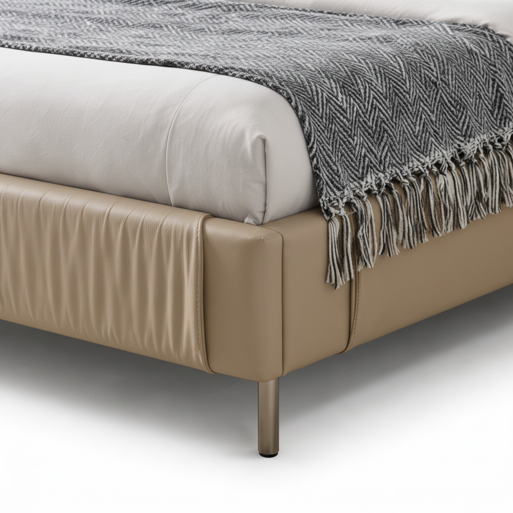 Zorvain Bed close-up of pleated footboard and metal support feet detail on a white background